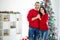 Portrait of charming married couple feel romance hug enjoy christmas time x-mas holidays in house with newyear