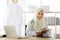 Portrait of charming muslim female doctor working at office desk and smiling at camera