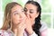 Portrait of a charming teenager girl with mom sharing secret