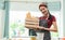 Portrait of charming woman carrying wooden round tray full of nourishing bread in the kitchen