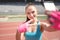 Portrait of charming woman taking a selfie, a picture of herself during training. Training, fitness and technology outdoors