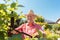 Portrait of a cheerful active senior man trimming shrubs in the garden