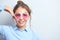 Portrait of a cheerful asian kazakh young woman in stylish glasses dressed casual smiling joyfully isolated on a white background