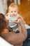 Portrait of cheerful baby playing on mamas knees