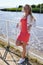 Portrait of cheerful blond young woman on river beach coast