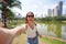 Portrait of cheerful Brazilian girl takes selfie in Vaca Brava Park in Goiania, Goias, Brazil