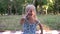 Portrait of a cheerful child girl in the park outdoors