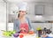 Portrait of a cheerful cooking woman in the kitchen