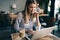 Portrait of cheerful coworker business woman working on laptop