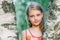 Portrait of cheerful cute little girl near the birch