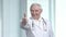 Portrait of cheerful doctor with thumb up.
