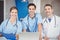 Portrait of cheerful doctors with laptop and clipboard