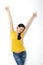 Portrait of cheerful European woman with hands raised pointing up