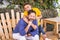Portrait of cheerful father and son couple outdoor together - happy family and diverse generations in love and friendship sitting