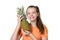 Portrait of a cheerful girl with a pineapple in her hands.