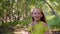 Portrait cheerful girl teenager walking in sunny forest at summer vacation. Smiling teen girl enjoying forest walk at