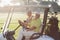 Portrait of cheerful golfer friends sitting in golf buggy