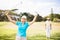 Portrait of cheerful golfer woman with arms raised