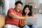 Portrait of cheerful korean spouses using laptop together