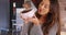 Portrait of cheerful Latina female holding up ceramic bowl, smiling at camera