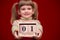 Portrait of cheerful little girl isolated on red hold wooden calendar set on first september