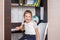 Portrait of a cheerful little girl studying in the first class. Workplace of young pupil. Happy child getting ready to do homework