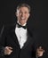 Portrait Of Cheerful Man In Tuxedo Gesturing