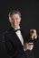 Portrait Of Cheerful Man In Tuxedo Opening Champagne Bottle