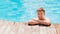 Portrait of a cheerful middle-aged man in the pool at the side.