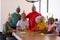 Portrait of cheerful multiracial seniors wearing party hats while celebrating friend\\\'s birthday