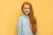 Portrait of cheerful positive red haired girl isolated