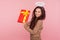 Portrait of cheerful pretty angelic young woman with halo holding big present and smiling to camera, satisfied with gift