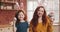 Portrait of cheerful redhead little kid girl with her mom playing with easter egg on the kitchen background. They are