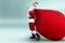 Portrait of a cheerful Santa Claus in a red suit carries a big bag, light background. Concept for christmas eve, vacation, holiday