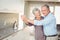 Portrait of cheerful senior man dancing with wife