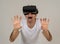 Portrait of cheerful and shocked young man wearing Virtual Reality headset exploring 3D world