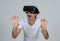 Portrait of cheerful and shocked young man wearing Virtual Reality headset exploring 3D world