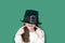 Portrait of cheerful smiling caucasian girl in fancy green leprechaun hat with gold buckle. concept promotion mockup. St