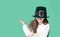 Portrait of cheerful smiling caucasian girl in fancy green leprechaun hat with gold buckle. concept promotion mockup. St