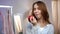 Portrait of cheerful woman eating red apple at home. Healthy woman eating fruit