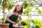 Portrait of a cheerful working woman in a nursery - Greenhouse w