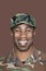 Portrait of a cheerful young African American US Marine Corps soldier over brown background