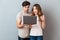 Portrait of a cheerful young couple using laptop computer