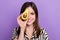 Portrait of cheerful young lady hide eye ripe half tasty green avocado vitamins for healthy lifestyle isolated on violet