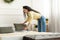 Portrait of cheerful young woman making bed after wake up