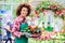 Portrait of a cheerful young woman working as florist in a modern flower shop