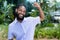 Portrait of cheering black businessman with full beard