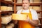 Portrait of cheesemaker in cellar, basement. Home cheese production, business