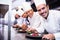 Portrait of chefs team finishing dessert plates