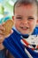 Portrait child with bathrobe with drawing pirate eating cookie